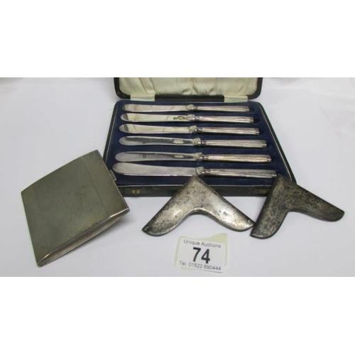 74 - A cased set of 6 silver handled butter knives, a silver cigarette case and 2 silver book corners