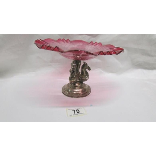 78 - A continental silver based comport with 3 horse heads and cranberry glass dish