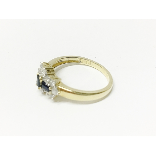 20 - A yellow gold baquette sapphire and diamond ring