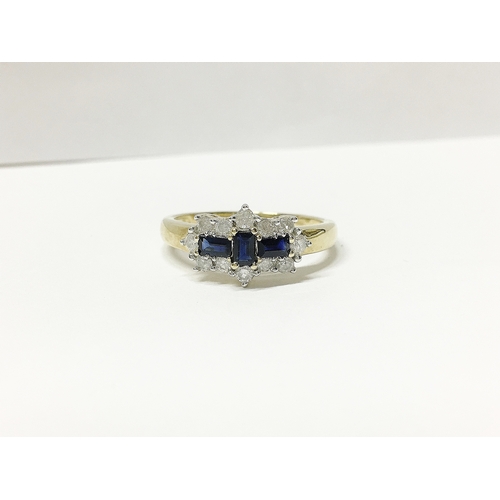 20 - A yellow gold baquette sapphire and diamond ring