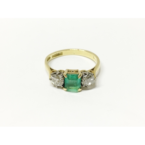 29 - An 18ct gold ring set with diamonds and emerald, size 0