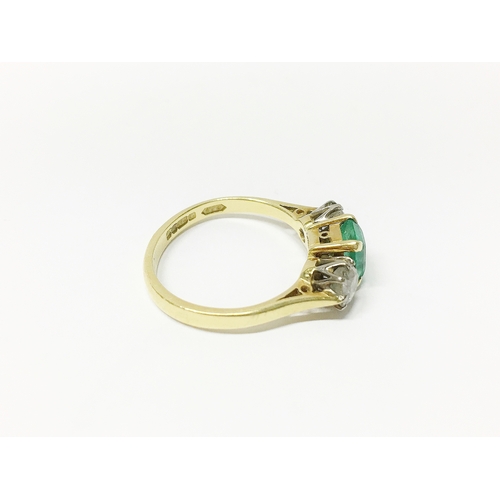 29 - An 18ct gold ring set with diamonds and emerald, size 0