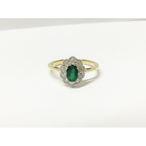 21 - A high carat yellow gold emerald and diamond ring, size 0