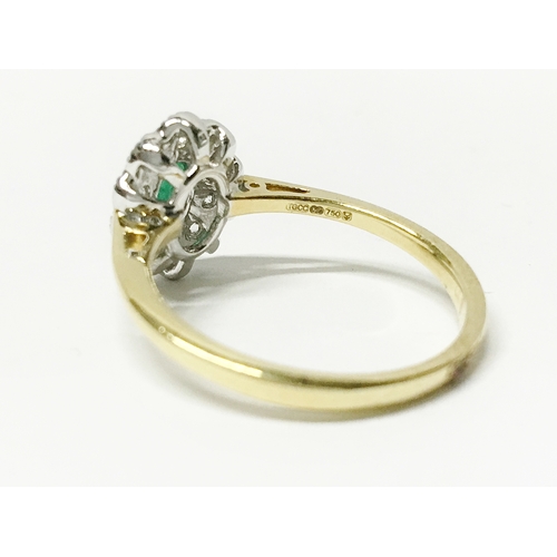 21 - A high carat yellow gold emerald and diamond ring, size 0