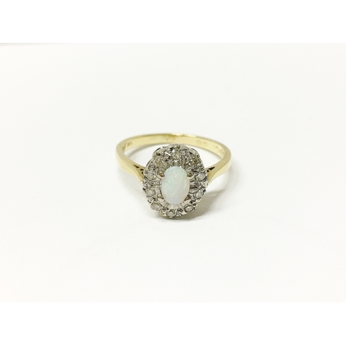 30 - An 18ct gold ring set with opal and diamond chips, size M