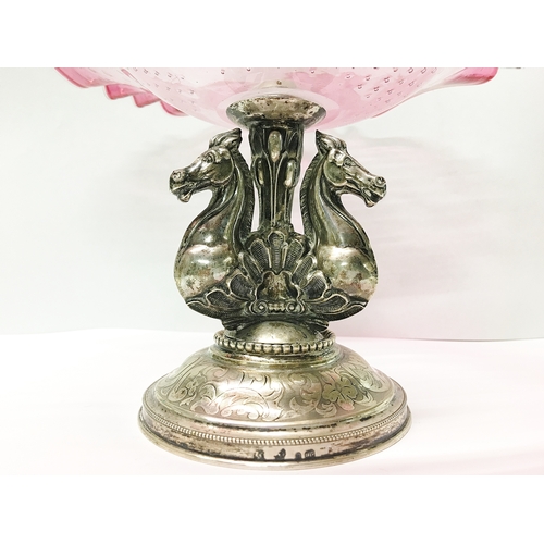 78 - A continental silver based comport with 3 horse heads and cranberry glass dish