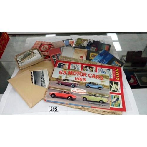 285 - A mixed lot including cigarette cards, commemorative stamps etc