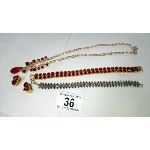 36 - A red stone set necklace, bracelet and earrings together with a white metal bracelet