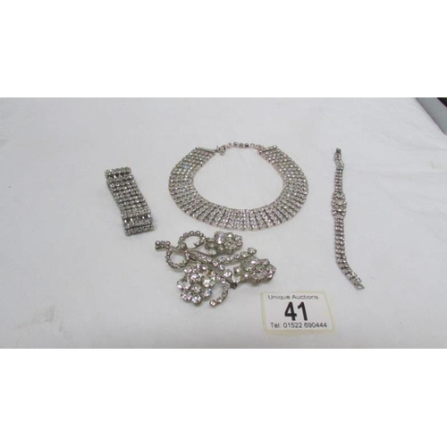 41 - A diamonte' choker with matching bracelet, one other bracelet and a brooch