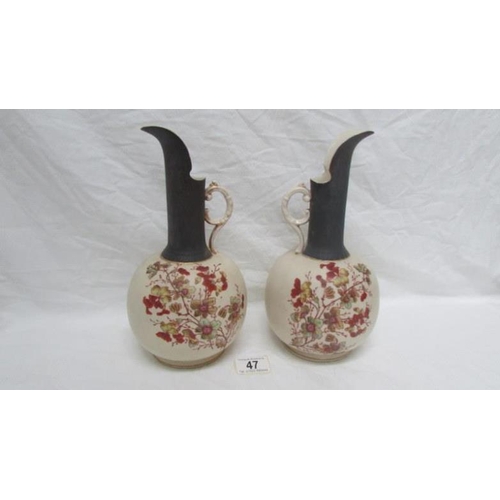 47 - A pair of 19th century hand painted porcelain ewers