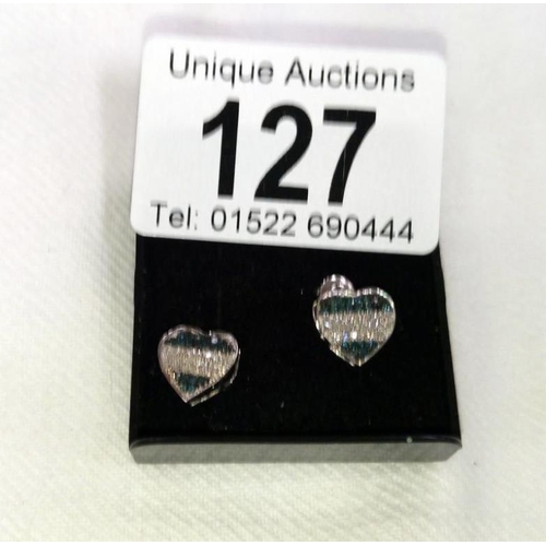 127 - A pair of black and white diamond heart shaped gold earrings