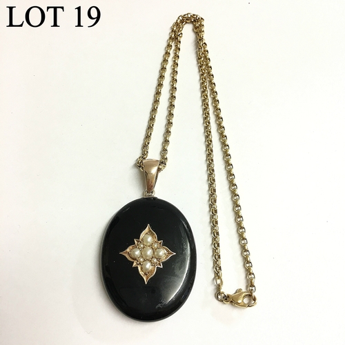 19 - A Victorian onyx pendant set with seven seed pearls and split pearls with locket back and set in gol... 