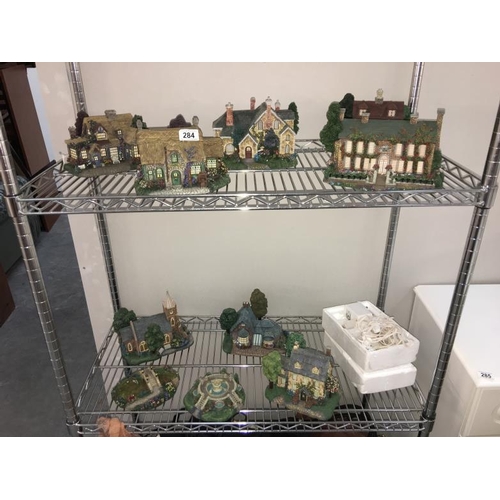 284 - A collection of Thomas Kinkade Hawthorne Village Cottages and accessories