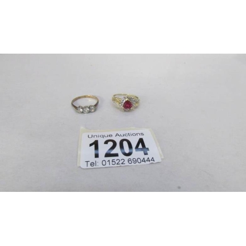 1204 - 2 9ct yellow gold dress rings, one being 3 stone and one heart shaped, sized S & U