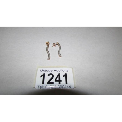 1241 - A pair of 9ct gold strand diamond earrings