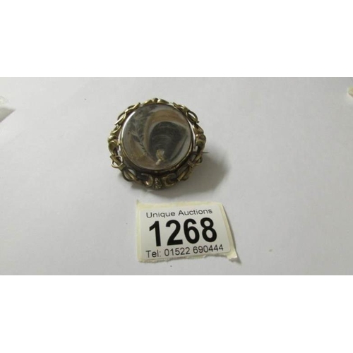 1268 - A Victorian swivel hair brooch with locket back