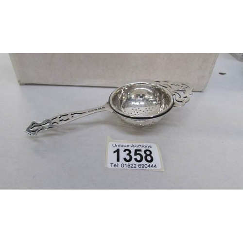 1358 - A silver tea strainer marked S Ltd, Birmingham 1923