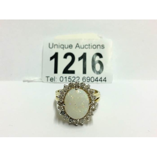 1216 - An 18ct white gold oval opal and diamond ring, size U