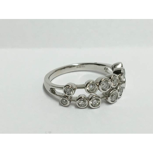 1224 - An 18ct white gold 2 bar ring of spaced diamonds