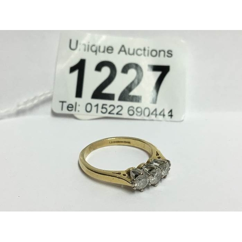 1227 - A 3 stone yellow gold half carat diamond ring, size O