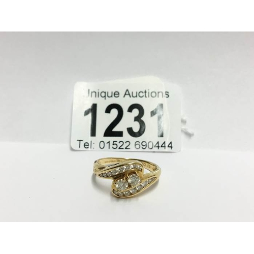 1231 - An 18ct gold 61pt diamond crossover ring, size P