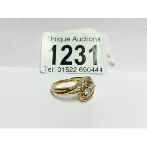 1231 - An 18ct gold 61pt diamond crossover ring, size P