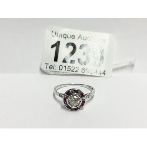 1239 - An 18ct gold ring cut diamond 30pts surrounded by rubies, size S