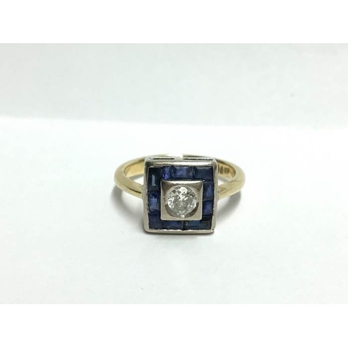 1243 - An 18ct yellow gold square shaped ring with centre 35pt diamond surrounded by sapphires, size U