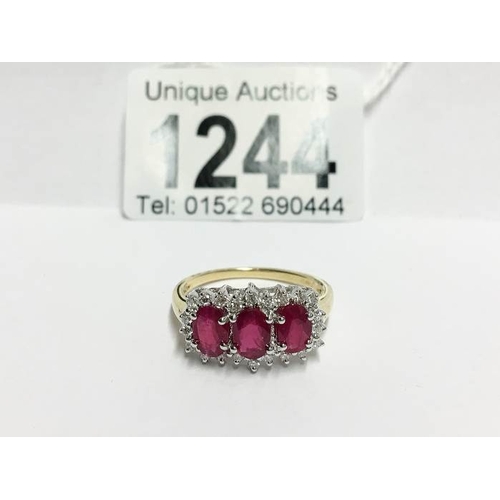 1244 - An 18ct yellow gold ring set ruby and diamonds, size T