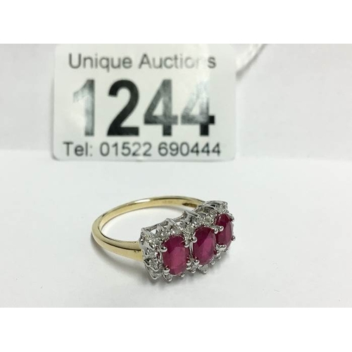 1244 - An 18ct yellow gold ring set ruby and diamonds, size T