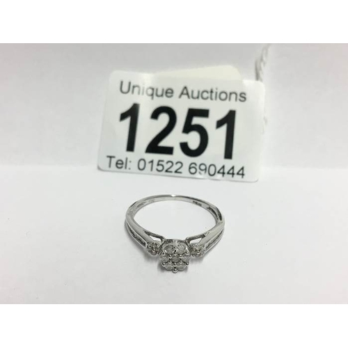 1251 - An 18ct white gold floral diamond ring with diamond shanks, size P