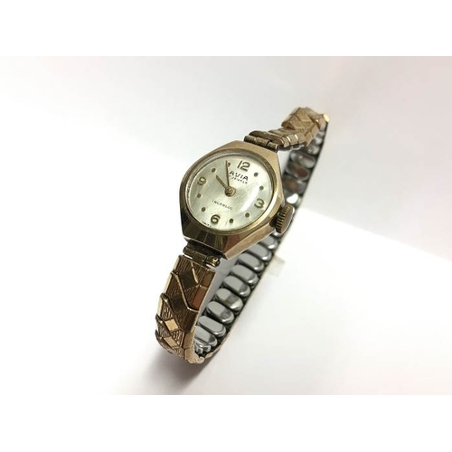 1373 - A 9ct gold ladies wrist watch on a yellow metal bracelet