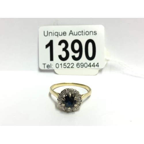 1390 - A vintage diamond and sapphire cluster ring set in 18ct gold, size V