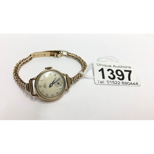 1397 - A Marvin ladies watch with twisted gold strap, all gold cased and in working order, 19.8gms