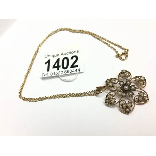 1402 - An Edwardian 9ct gold seed pearl pendant