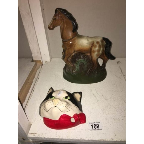 109 - A novelty Apaloosa horse whisky bottle and a cats head string holder