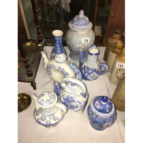 134 - A quantity of oriental blue and white items including teapots, lidded pots etc