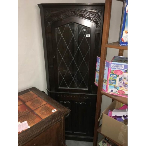 15 - A dark oak stained corner cupboard