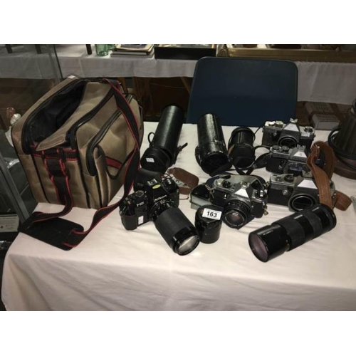 163 - A quantity of 35mm cameras with lenses including Pentax and Practica