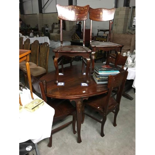 186 - A mahogany dining table and 6 chairs with brass inlay