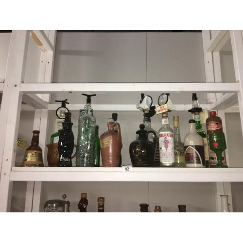 92 - A quantity of assorted alcohol bottles some with contents