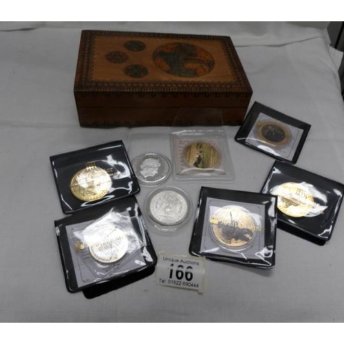 166 - A quantity of commemorative coins including £5 in a wooden box