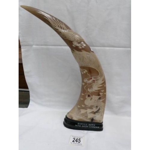 245 - A buffalo horn with Asian carvings