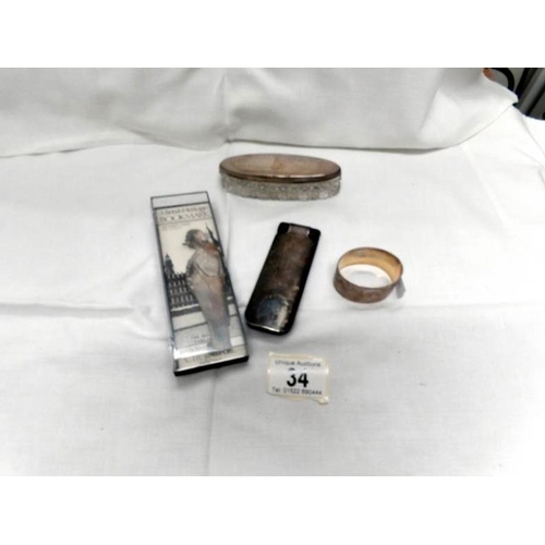 34 - A silver topped pot, a silver salt, a silver napkin ring, a silver plated nail buffer and a Churchil... 