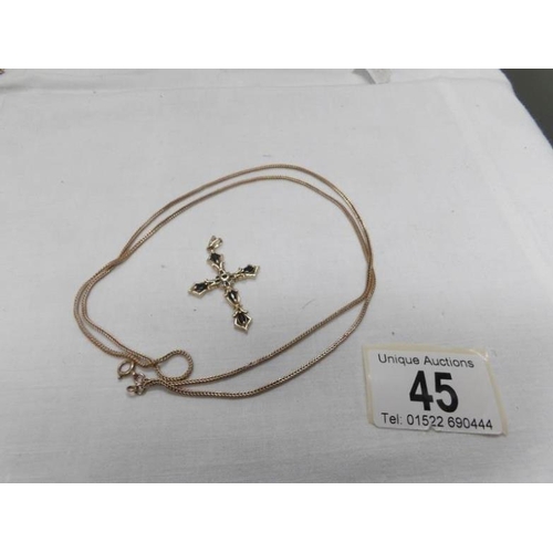 45 - A 9ct gold cross pendant and a 9ct gold chain