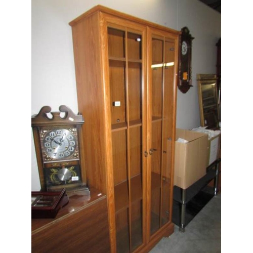 1035 - A modern teak glazed book case