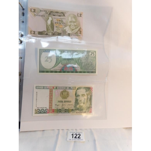 122 - An album of approximately 60 uncirculated and high quality world bank notes