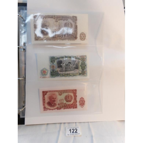 122 - An album of approximately 60 uncirculated and high quality world bank notes