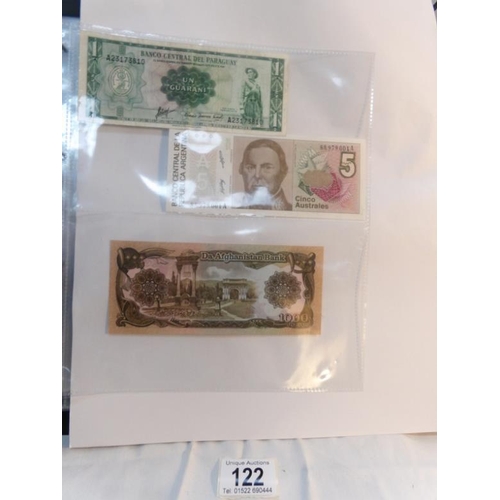 122 - An album of approximately 60 uncirculated and high quality world bank notes