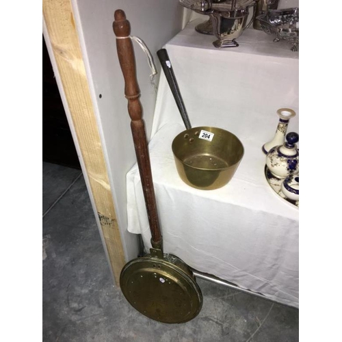 204 - A brass warming pan and a brass saucepan